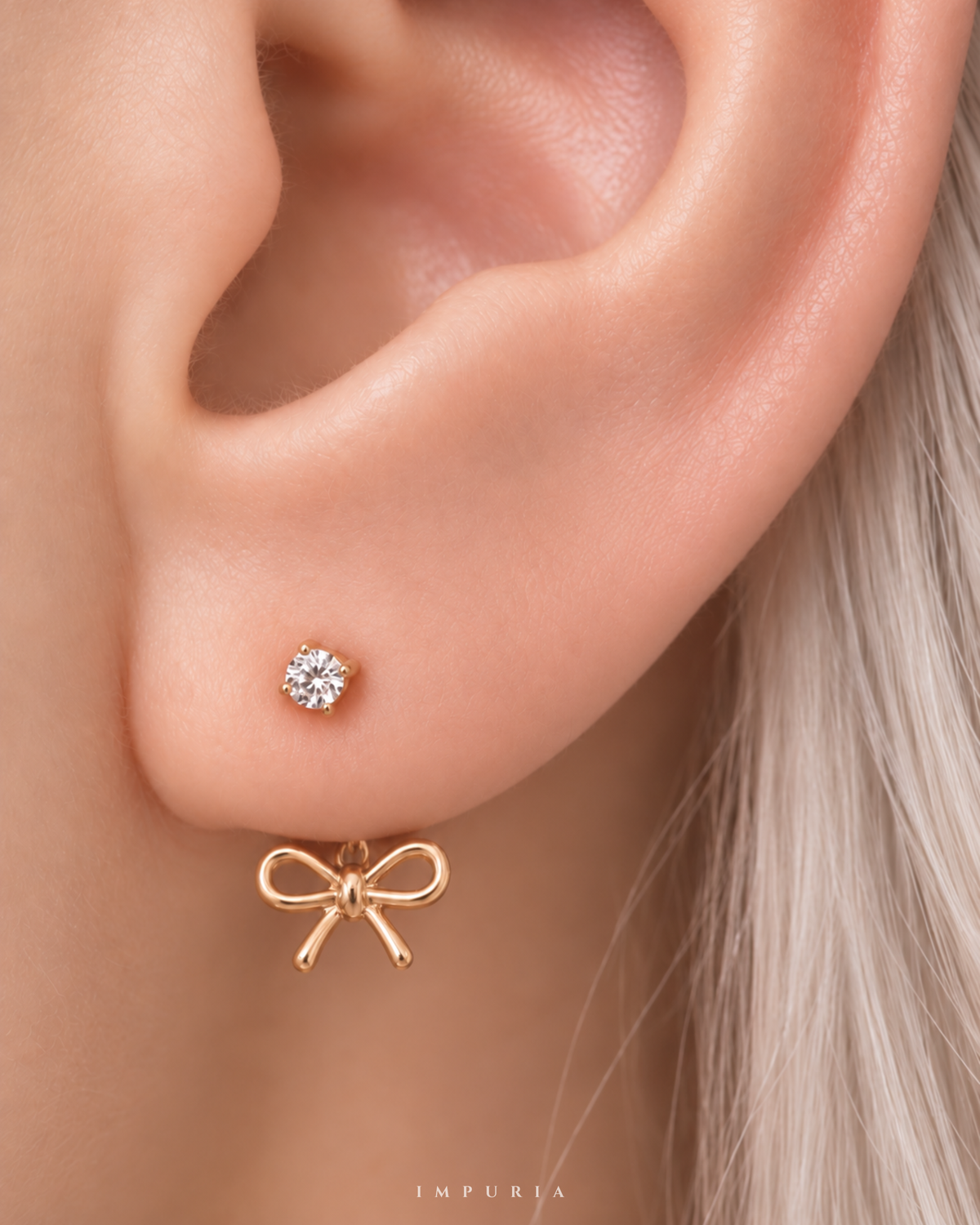 amour open bow hoop earring in gold on lobe