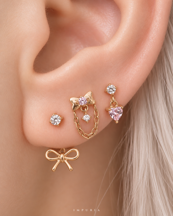 amour coquette bow heart earring stack capsule in gold on lobe