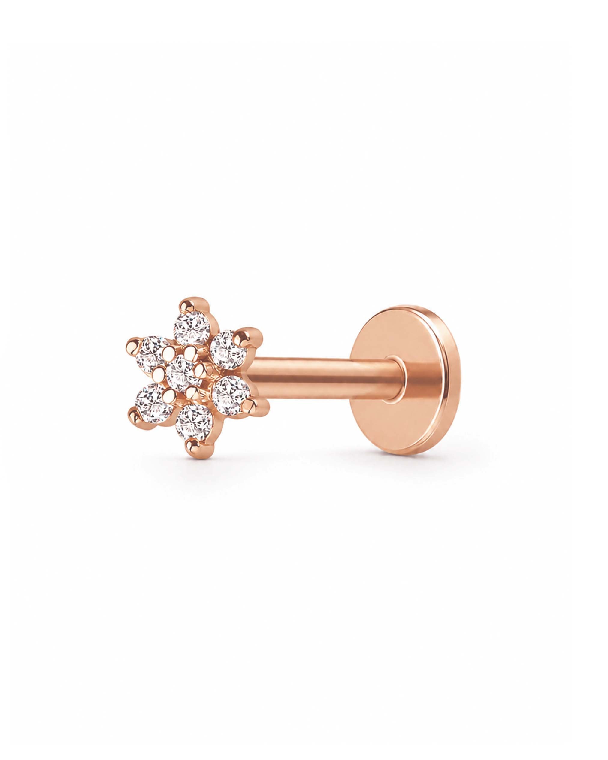 A rose gold flat-back labret stud earring featuring a small cluster of clear round-cut gemstones in a floral snowflake-like design, shown from a side profile on a clean white background.
