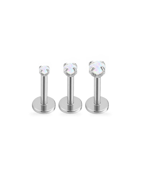 Three silver-toned labret piercings with round iridescent opal clear gemstones, arranged by size on a plain white background.