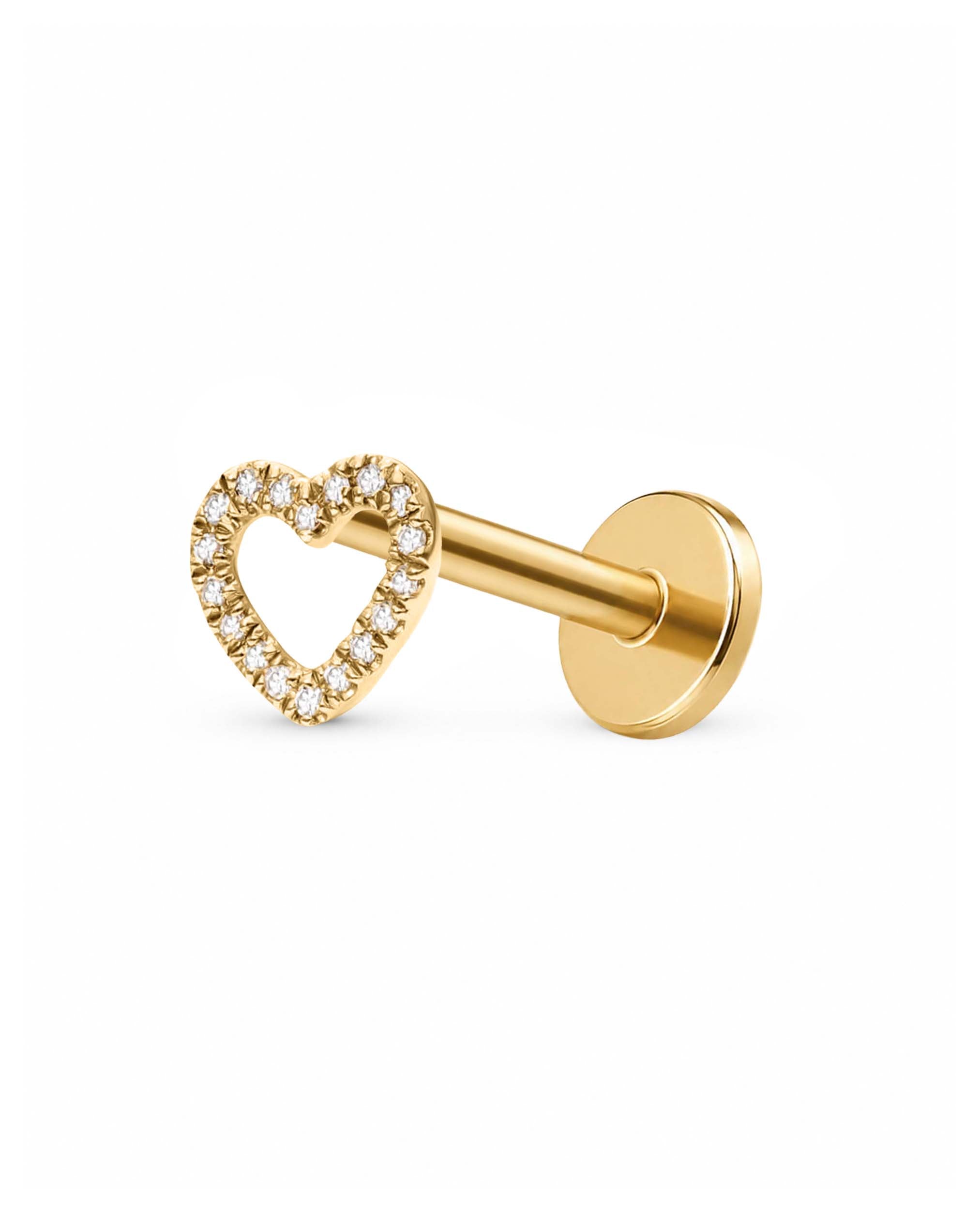 A gold body jewelry piece featuring a heart-shaped stud adorned with small clear pavé stones, shown on a plain white background.