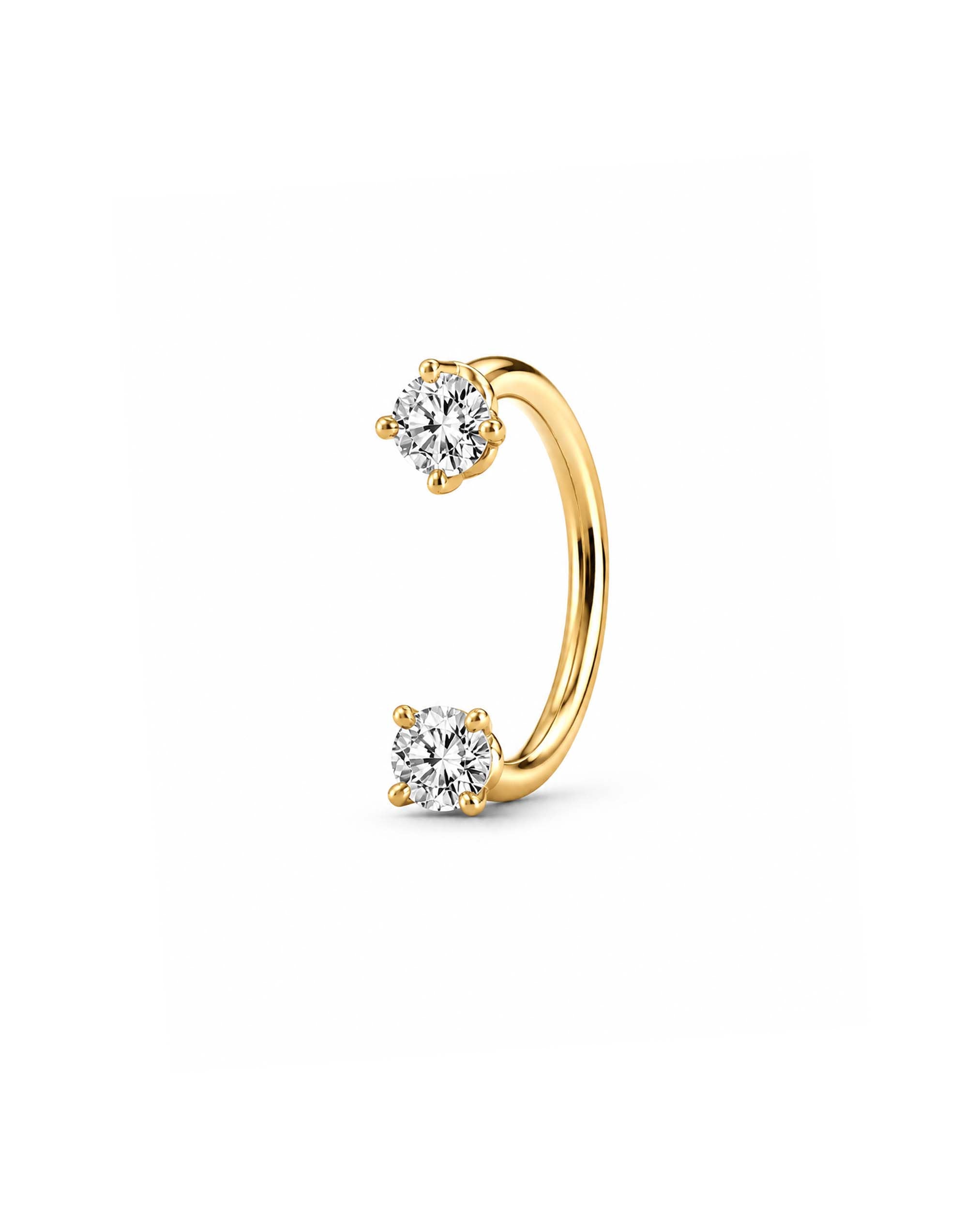 A gold U Hoop horseshoe barbell earring   featuring two round-cut clear gemstones, one at each end, set in a four-prong setting against a plain white background.
