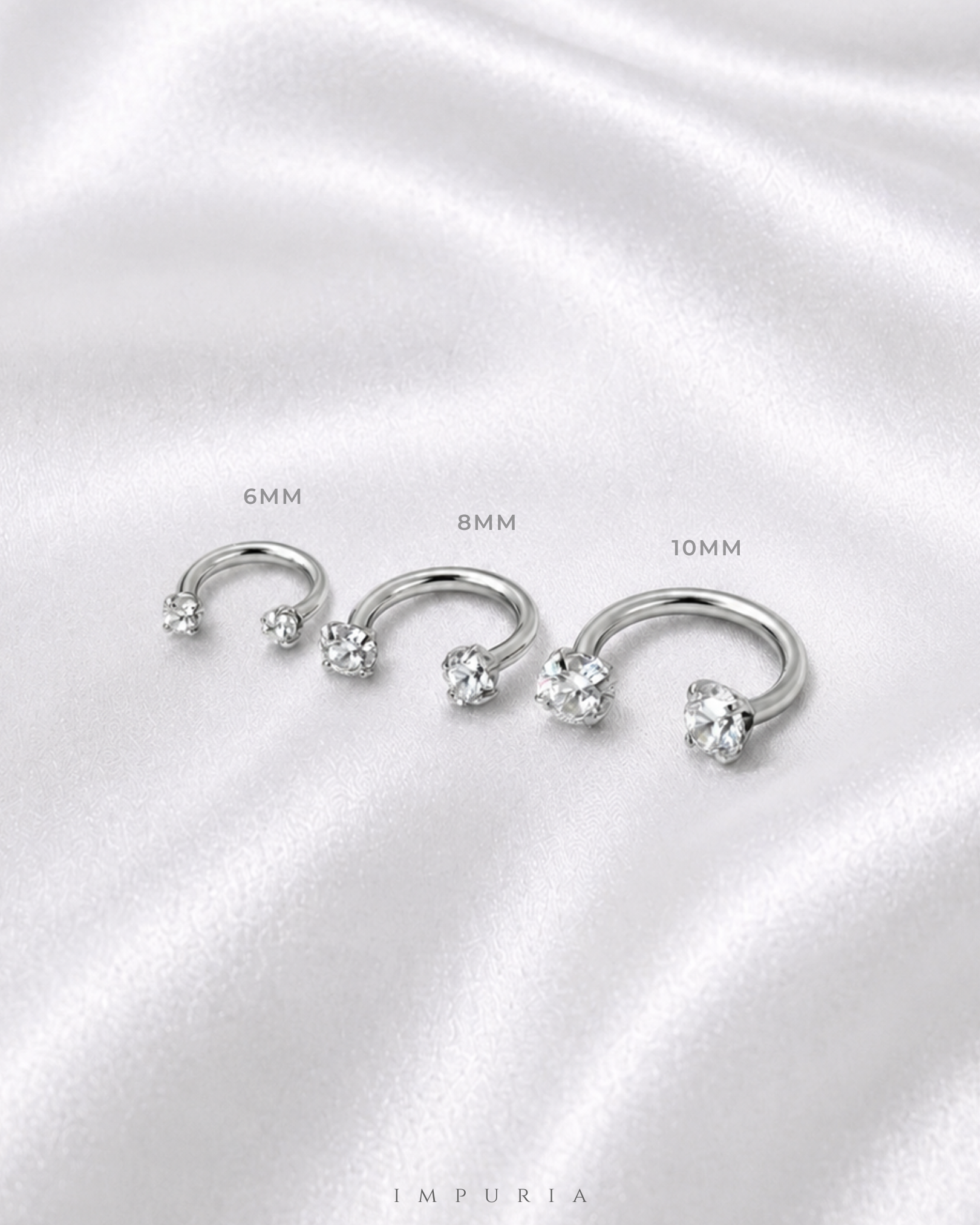 U Hoop horseshoe barbell earring size comparison on silk background
